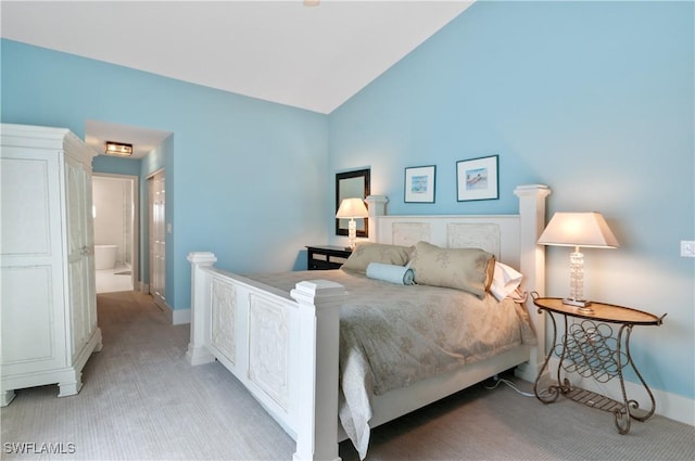 bedroom featuring vaulted ceiling, baseboards, and light carpet