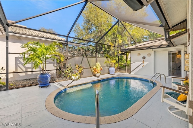 pool with glass enclosure and a patio