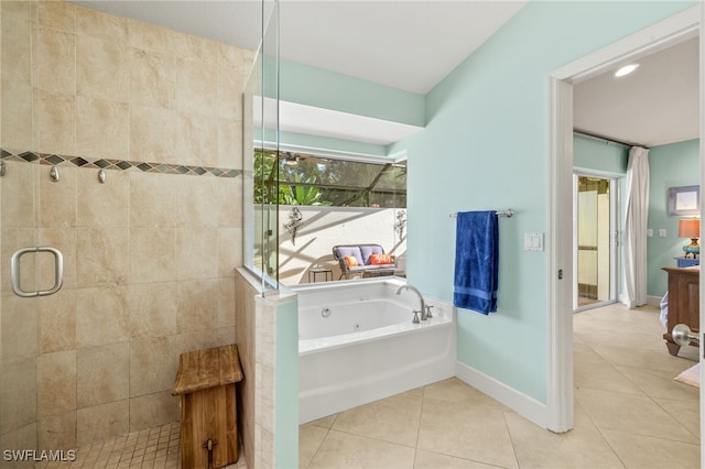 full bathroom with a tub with jets, tiled shower, tile patterned flooring, and baseboards