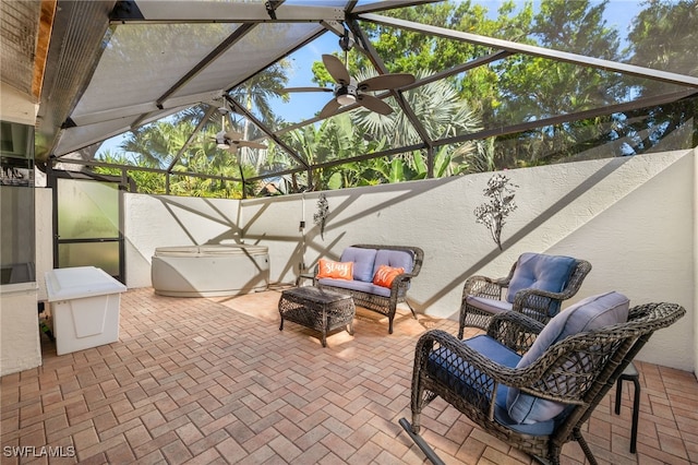 view of patio featuring glass enclosure and an outdoor hangout area