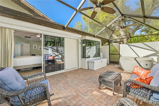 sunroom / solarium featuring lofted ceiling, a healthy amount of sunlight, and ceiling fan