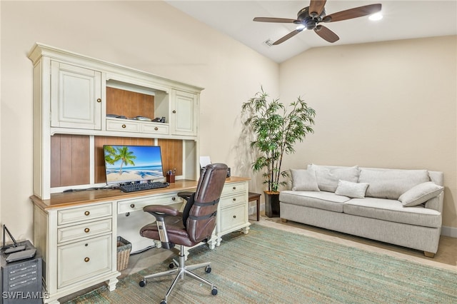 office space featuring baseboards, visible vents, vaulted ceiling, and a ceiling fan