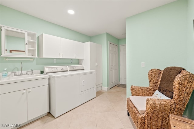 laundry area featuring light tile patterned floors, recessed lighting, a sink, and washer and dryer