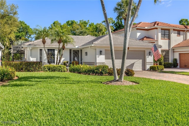 view of front facade featuring a garage, a front yard, and a tiled roof