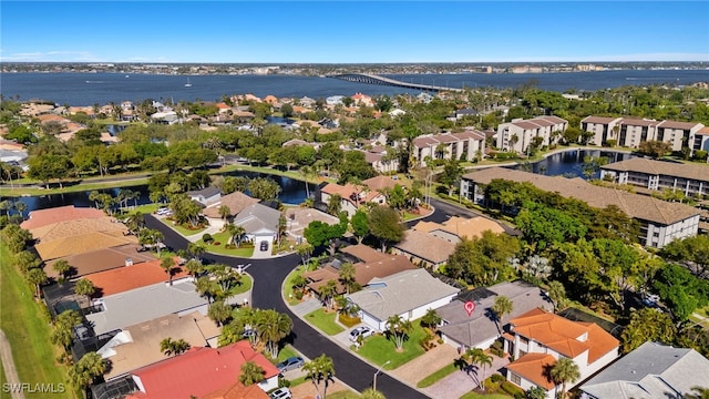 drone / aerial view with a residential view and a water view