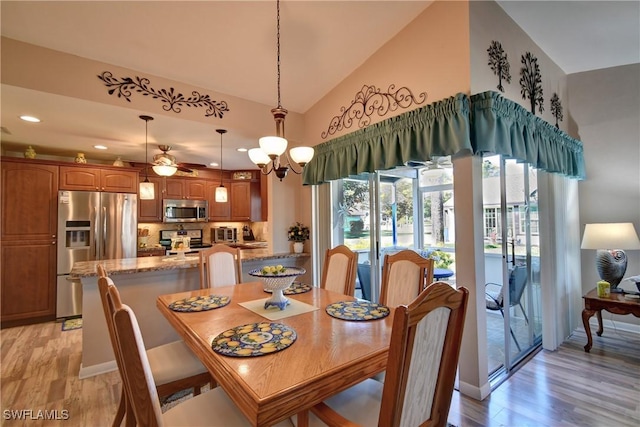 dining space featuring baseboards, recessed lighting, ceiling fan, vaulted ceiling, and light wood-style floors