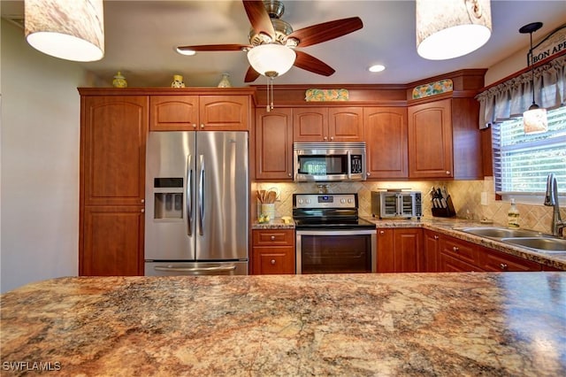 kitchen with tasteful backsplash, appliances with stainless steel finishes, brown cabinetry, and a sink