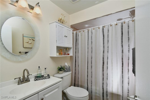 bathroom with toilet and vanity