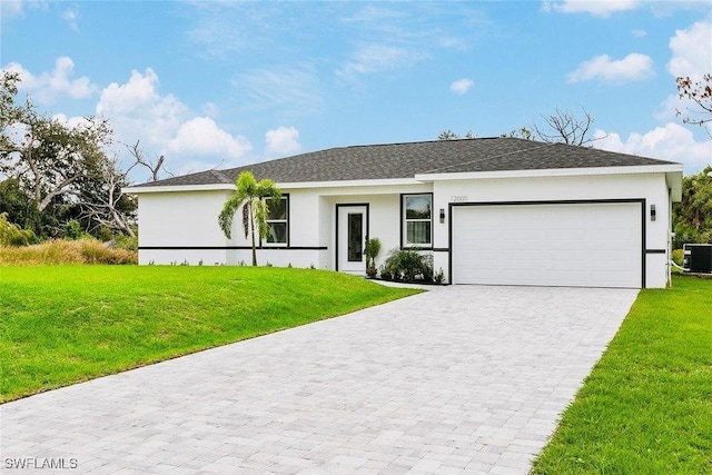 ranch-style house with decorative driveway, stucco siding, an attached garage, central AC, and a front lawn