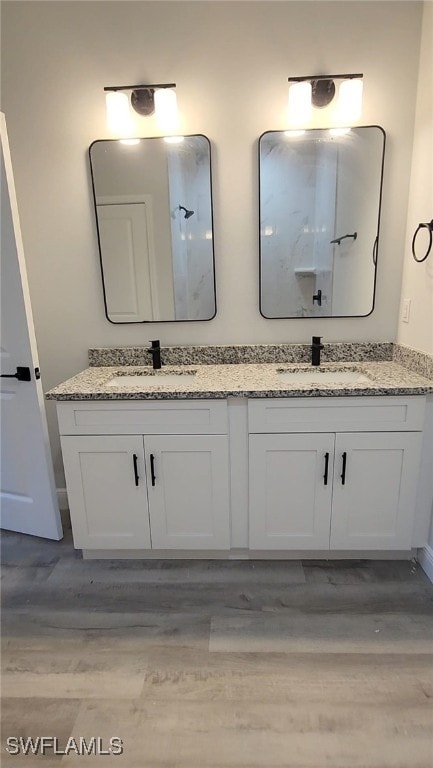 bathroom featuring double vanity and a sink