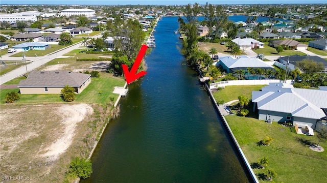 drone / aerial view featuring a water view and a residential view