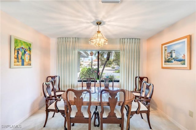 dining space featuring baseboards, visible vents, light colored carpet, and a notable chandelier