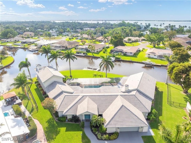 drone / aerial view with a residential view and a water view