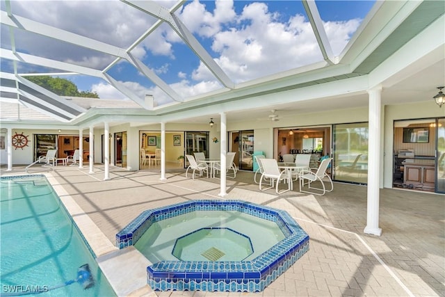 outdoor pool with a ceiling fan, a patio, glass enclosure, an in ground hot tub, and outdoor dining area