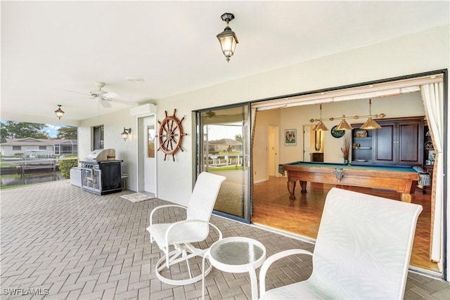 interior space with a ceiling fan, an AC wall unit, and a grill