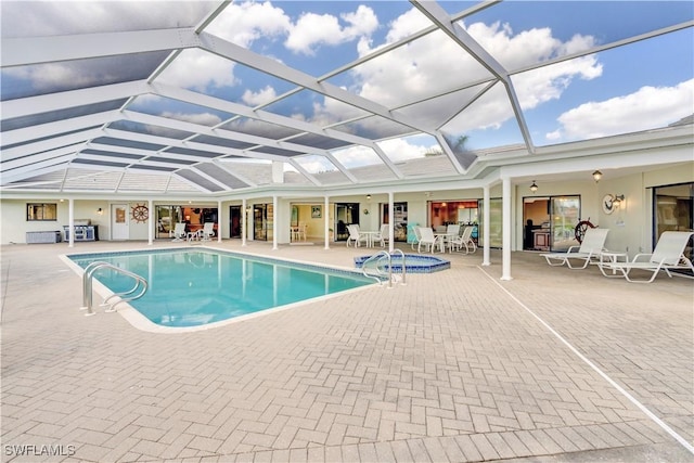 outdoor pool featuring a lanai and a patio