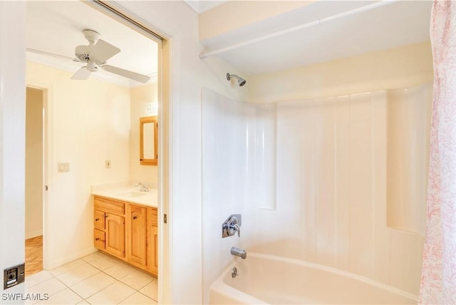 bathroom featuring baseboards, ceiling fan, tile patterned flooring, vanity, and shower / washtub combination