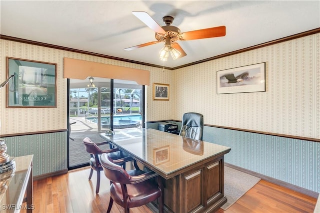 home office featuring wallpapered walls, light wood finished floors, and crown molding