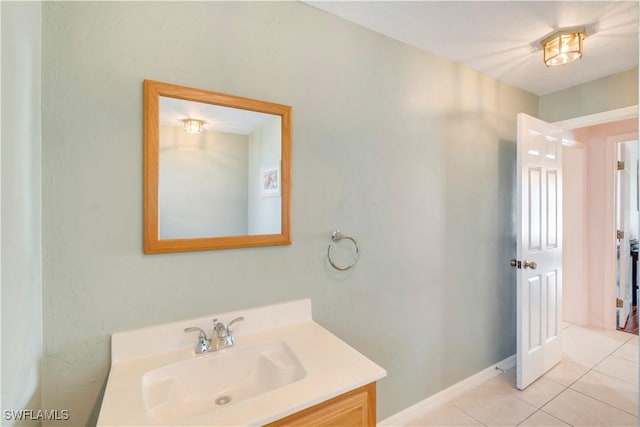 bathroom featuring vanity, baseboards, and tile patterned floors