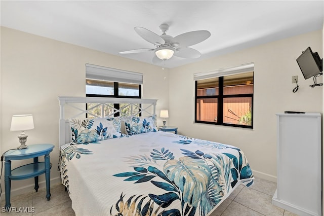 bedroom featuring tile patterned floors, ceiling fan, and baseboards