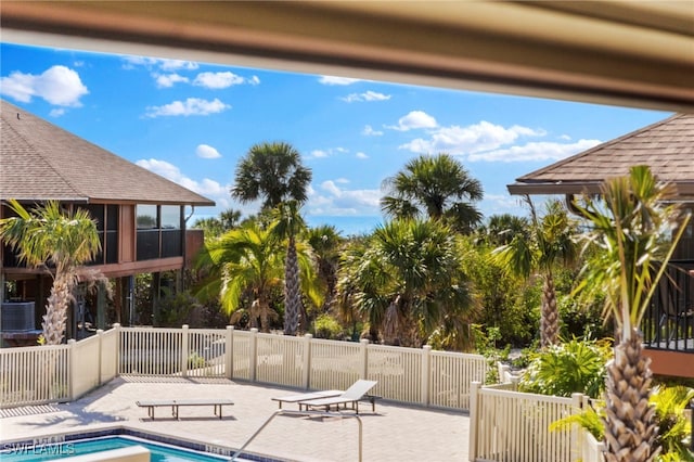 view of pool featuring a fenced in pool, a patio, central AC, and fence