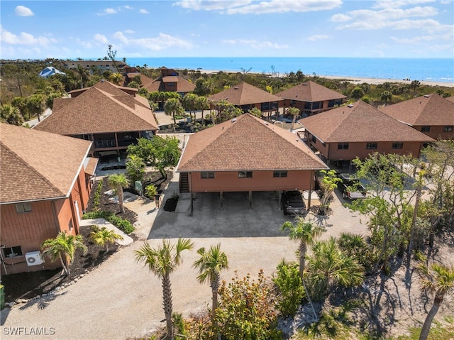 drone / aerial view featuring a residential view and a water view