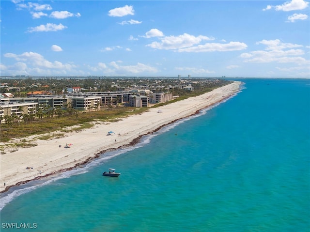 aerial view with a water view, a view of city, and a beach view