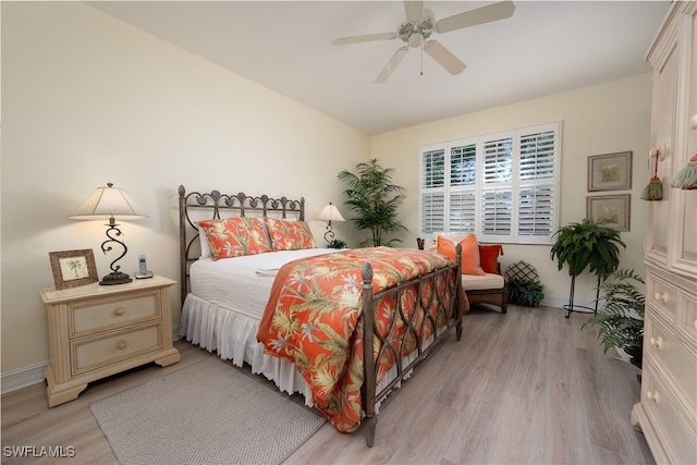 bedroom featuring light wood-type flooring, a ceiling fan, and baseboards