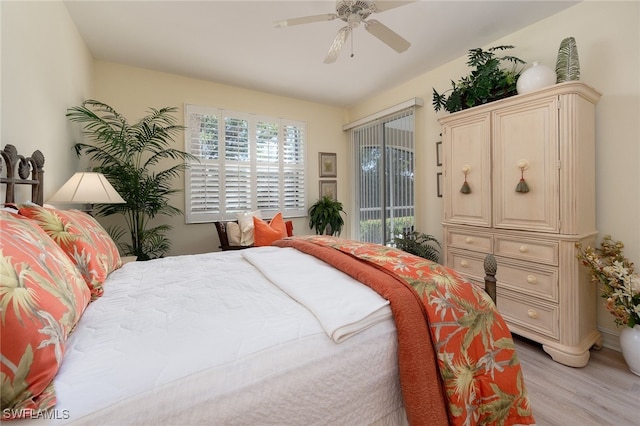 bedroom featuring a ceiling fan, light wood-style flooring, and access to exterior