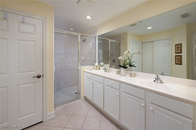 full bathroom with tile patterned flooring, visible vents, a sink, and a shower stall