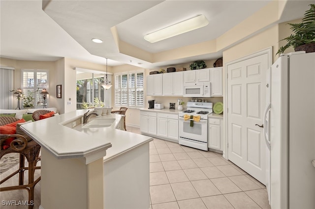 kitchen with white appliances, white cabinets, light countertops, a sink, and light tile patterned flooring