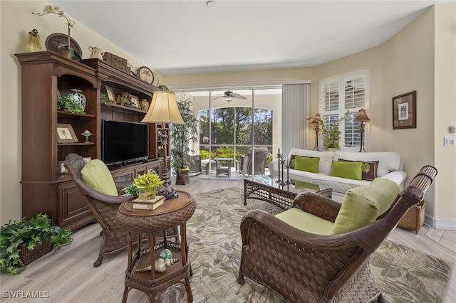 sitting room featuring a sunroom and light wood-style flooring