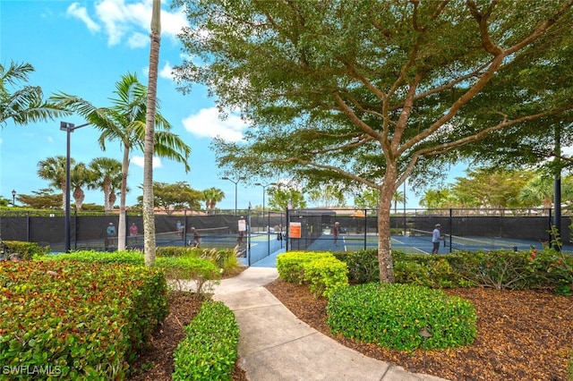 view of tennis court featuring fence