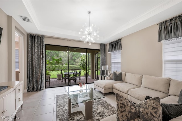 living area with visible vents, a raised ceiling, crown molding, a chandelier, and light tile patterned flooring