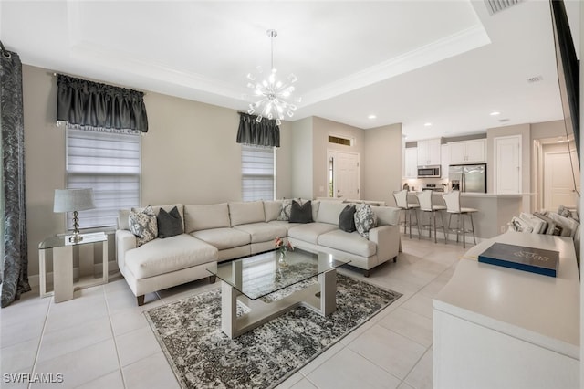 living area with light tile patterned floors, a chandelier, visible vents, ornamental molding, and a raised ceiling