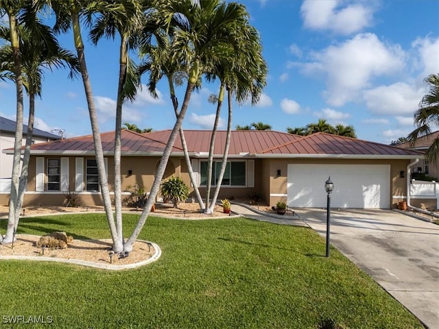 single story home with stucco siding, a front yard, a garage, and driveway