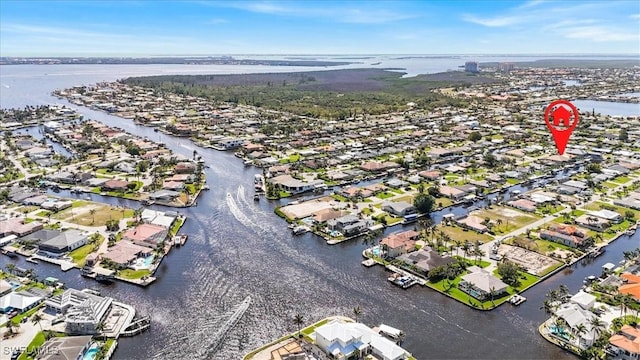 drone / aerial view with a water view and a residential view