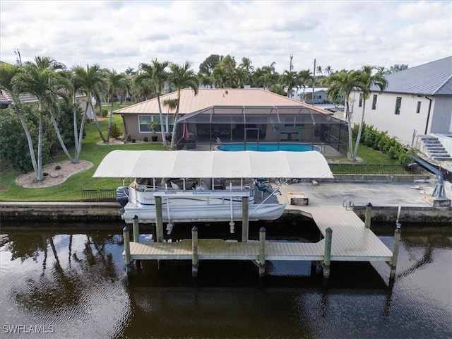 dock area with a water view, a lawn, fence, glass enclosure, and an outdoor pool