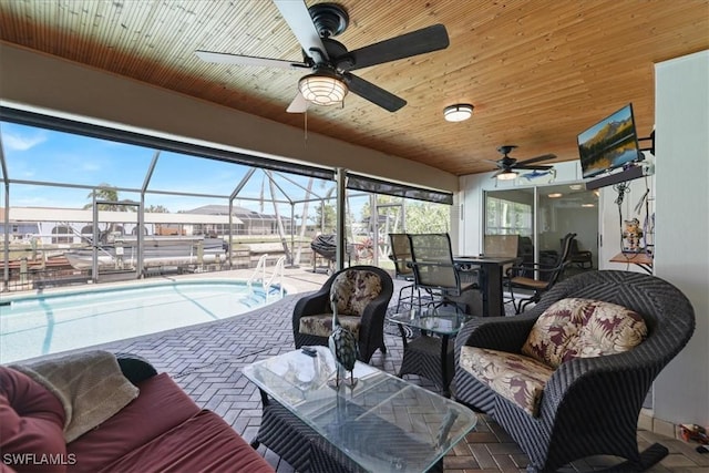 view of patio with ceiling fan, glass enclosure, outdoor lounge area, outdoor dining space, and an outdoor pool