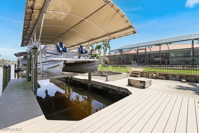 view of dock with glass enclosure, fence, a water view, and boat lift