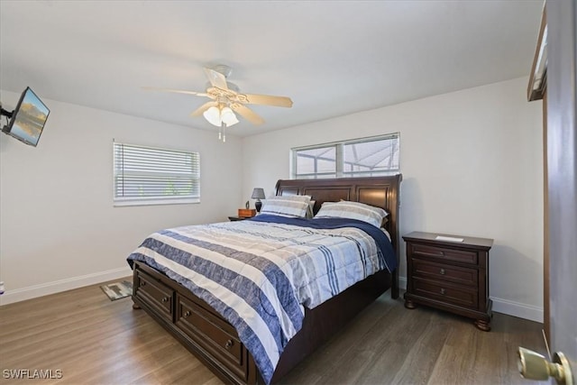 bedroom with ceiling fan, baseboards, and wood finished floors