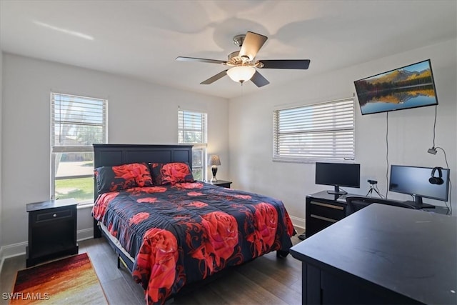 bedroom featuring ceiling fan, baseboards, and wood finished floors