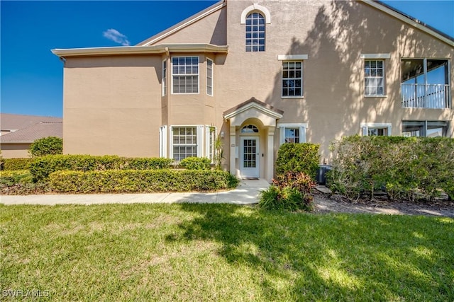 view of front of property with a front yard and stucco siding