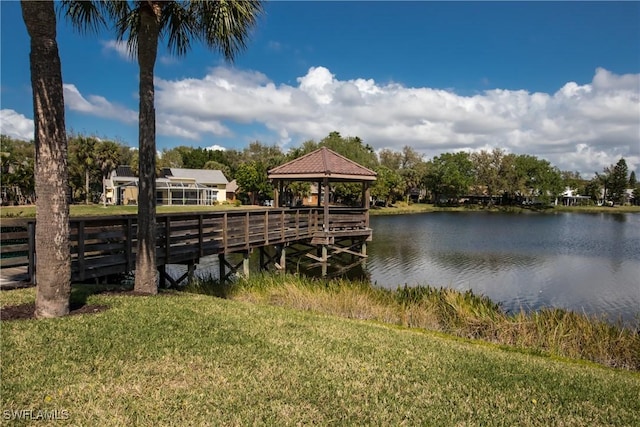 dock area featuring a water view, a yard, and a gazebo