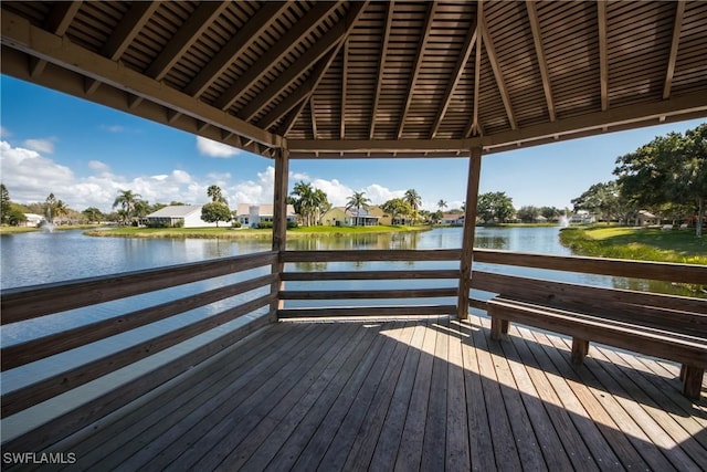 view of dock with a gazebo and a deck with water view