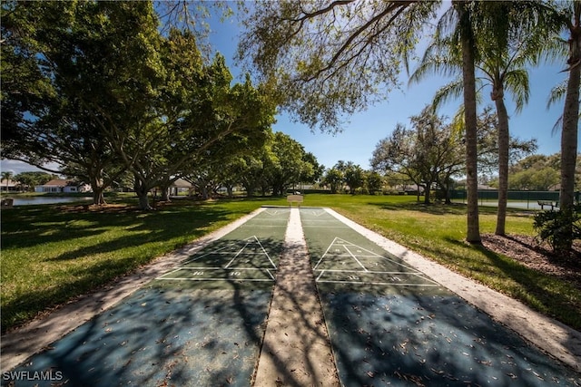 view of home's community featuring shuffleboard and a lawn