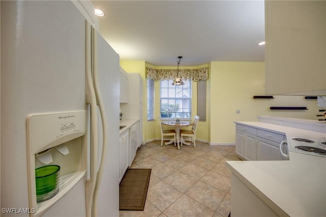 9321 Alamander Ct Unit 204, Fort Myers, FL 33919 - kitchen with white fridge with ice dispenser, decorative light fixtures, light tile patterned floors, and light countertops
