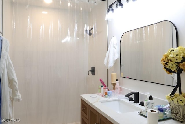 full bathroom featuring curtained shower and vanity