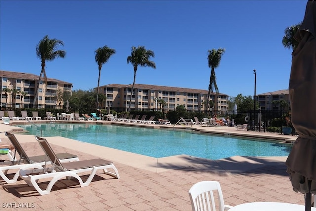 pool featuring a patio area and fence