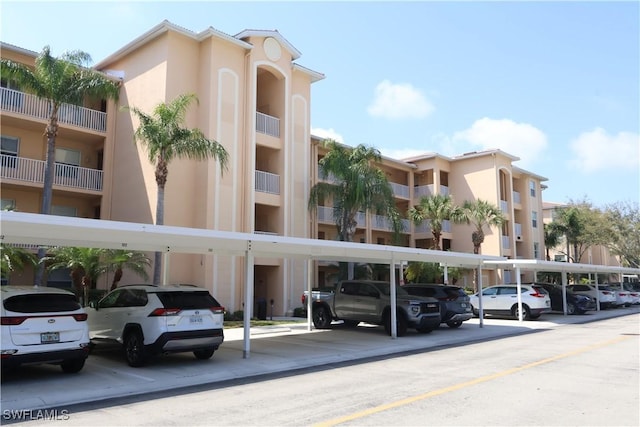 view of building exterior featuring covered parking